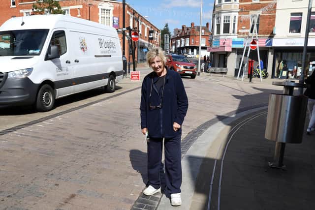Val Wilson with the drains in Market Street, Wellingborough