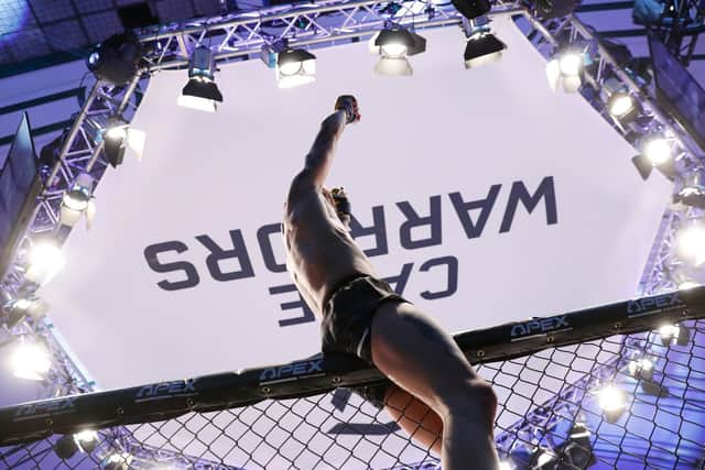 Jordan Vucenic celebrates at the top of the cage after he became the Cage Warriors featherweight champion. Pictures by Dolly Clew (www.dollyclew.com)