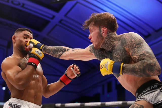 Jordan Vucenic lands a blow on Morgan Charrière during their featherweight title bout