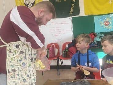 Children learn cooking skills from experts.