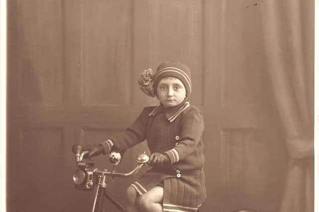 On her trusty tricycle