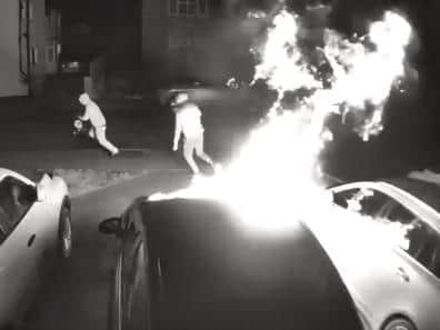 Security cameras caught the two yobs setting light to cars on a Weedon driveway at 1.49am on Tuesday morning
