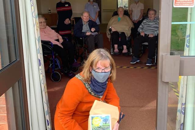 Melanie Coleman making a socially distanced doorstep delivery of Easter cards