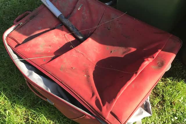 The suitcase and spade found at Pen Green Balancing Lakes