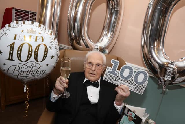 John Young in dinner jacket and bow tie celebrating in style