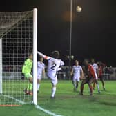 Dan Nti (in the background) holds his head after his late effort struck the post in Kettering Town's 0-0 draw with Hereford. Pictures by Peter Short