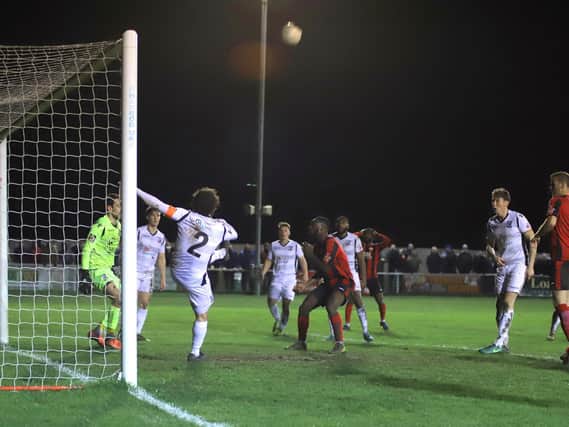 Dan Nti (in the background) holds his head after his late effort struck the post in Kettering Town's 0-0 draw with Hereford. Pictures by Peter Short