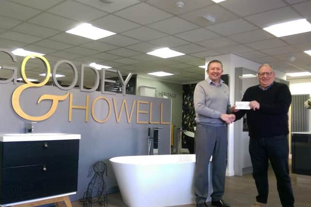 Glamis Hall volunteer driver Trevor Coates receiving the cheque from Karl Howell