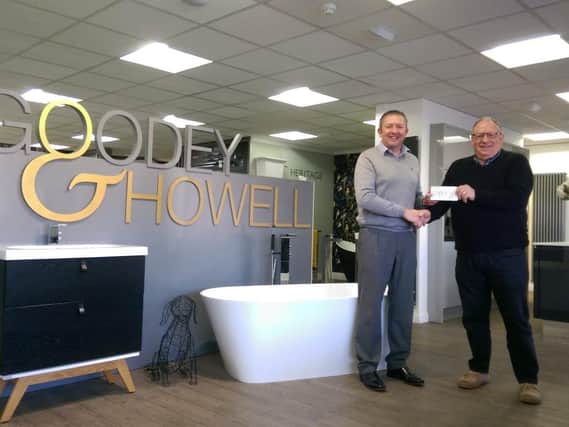 Glamis Hall volunteer driver Trevor Coates receiving the cheque from Karl Howell