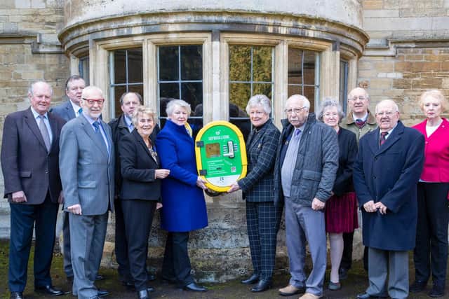 Members of Rushden Town Council with one of the six defibrillators they have bought for the town