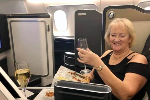 Sally Abel enjoys a glass of bubbly on the flight back to Heathrow