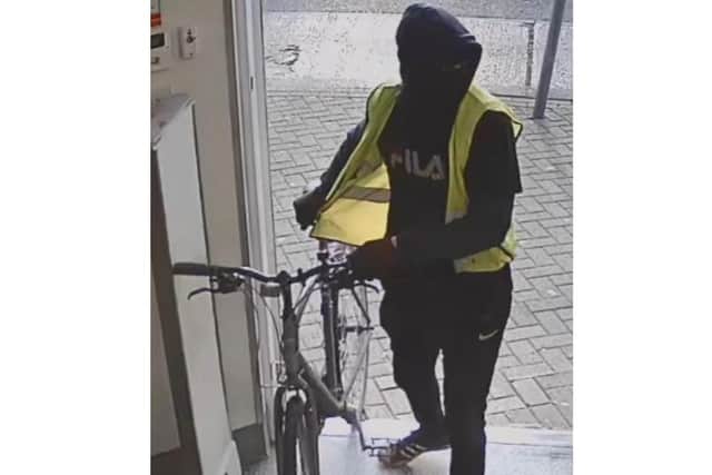 Police want to speak to this man after a shop in Corby was robbed