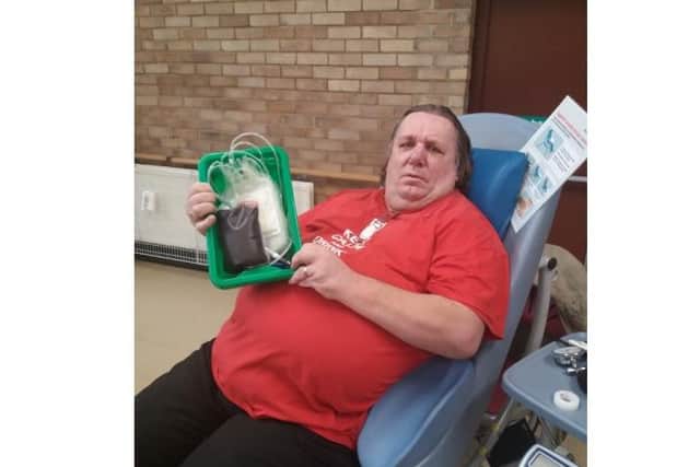 Steve Dines after he had just completed his 100th blood donation.