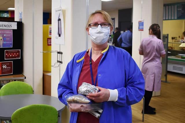 A member of staff picks up her free breakfast.