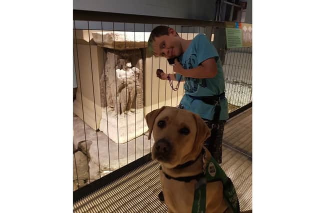 Ty with his assistance dog Denby