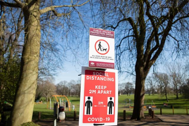 Warning signs about social distancing are up at the county's parks. Photo: Leila Coker