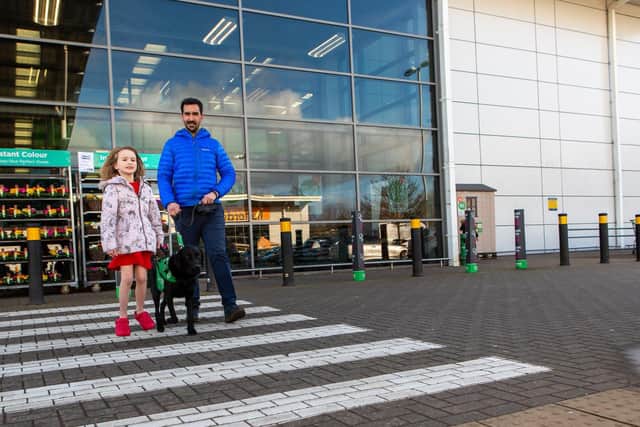 Steven, Emily and Oslo on a shopping trip. Photo: Dogs for Good
