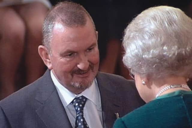 Ralph Baxter receiving his MBE from The Queen in 2007