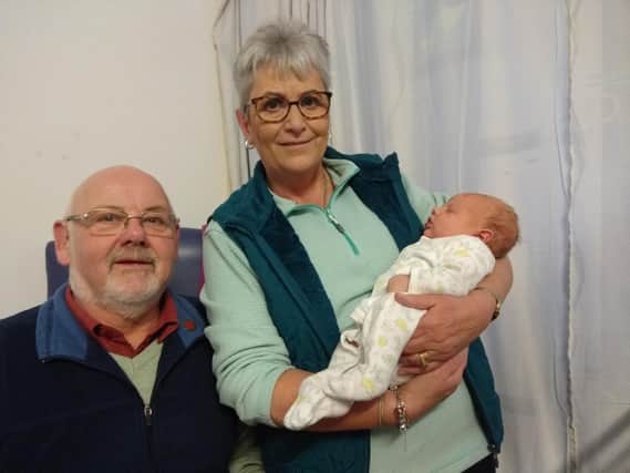 Ruth and husband Richard with their new grandson