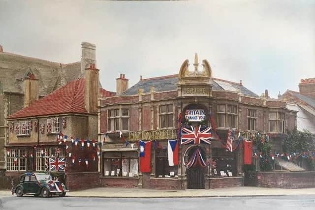 Speight's photography studios on 'Speight's Corner' - the corner of London Road and  Bowling Green Avenue covered in bunting for VE Day.