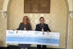 Cllr Richard Levell with the cheques for his fundraising