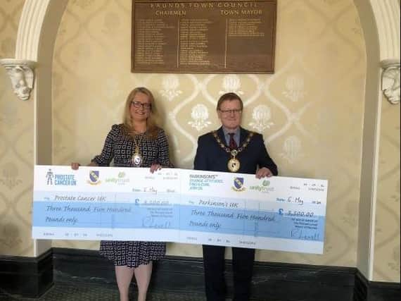 Cllr Richard Levell with the cheques for his fundraising