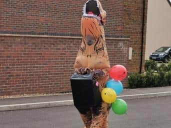 The eight-foot-tall PhiloSaurusRex has been visiting - at a social distance people who need cheering up during lockdown