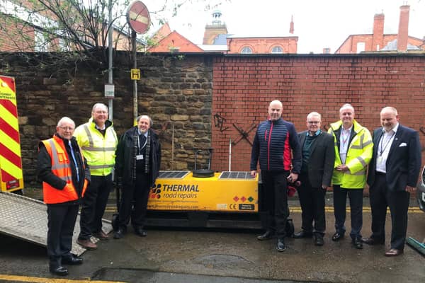 Councillors are pictured with one of the new thermal repair machines.