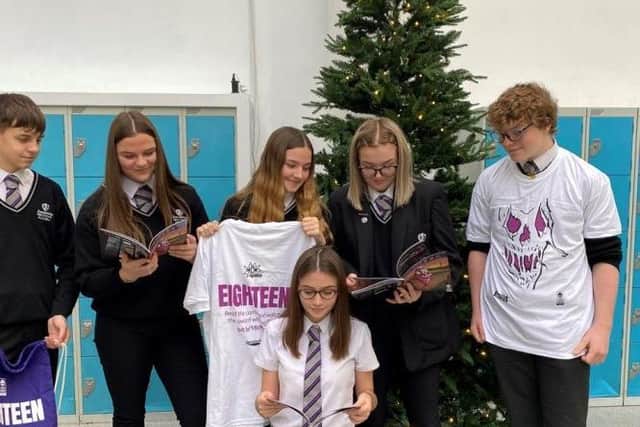 Kingswood Academy students inspect their handiwork after the comic's launch in December