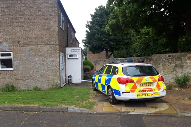 Police at the scene in Pages Walk, Corby, today