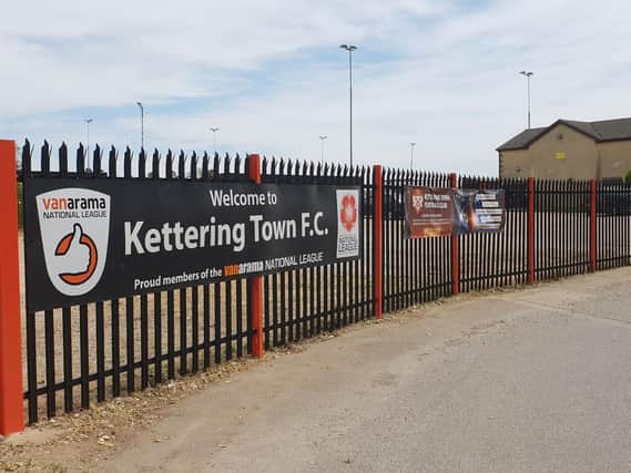 The fencing outside Latimer Park has now been painted in Kettering Towns red and black colours. Picture by Peter Short