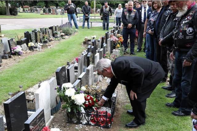 A friend of Alexs and fellow Falklands War veteran Joe McMahon, also from Corby, places a Poppy cross on Alex's grave.