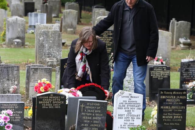 Susan and Colin Fleming place a wreath on Alex's grave