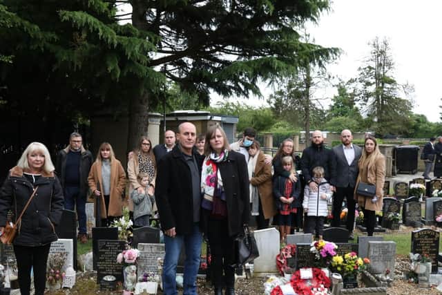 Susan Fleming and her family at her brother Alex Shaw's grave