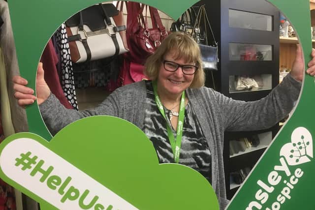 Cransley Hospice shop volunteer Mary Carr shows her support for keeping it local