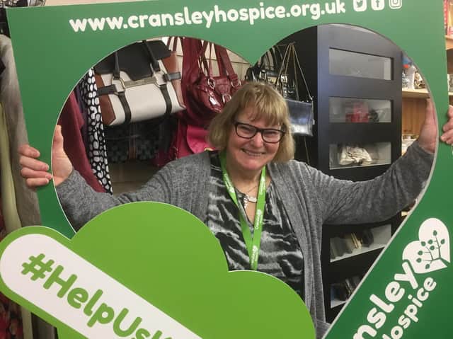Cransley Hospice shop volunteer Mary Carr shows her support for keeping it local
