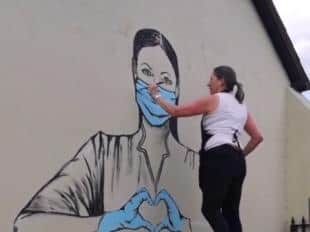 Eunice Friend had to be lifted by a forklift to paint the 8ft mural