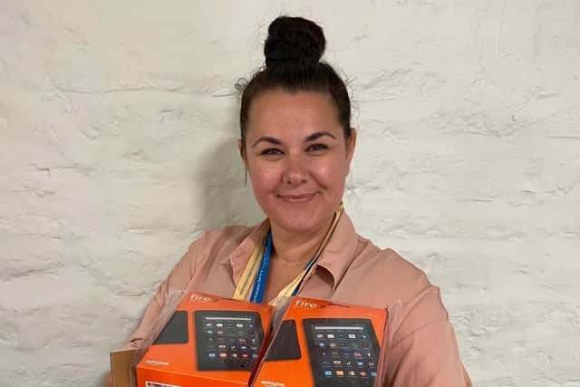 Patient experience lead Rachel Lovesy holding the tablets which were donated as part of the Amazon wish list appeal.