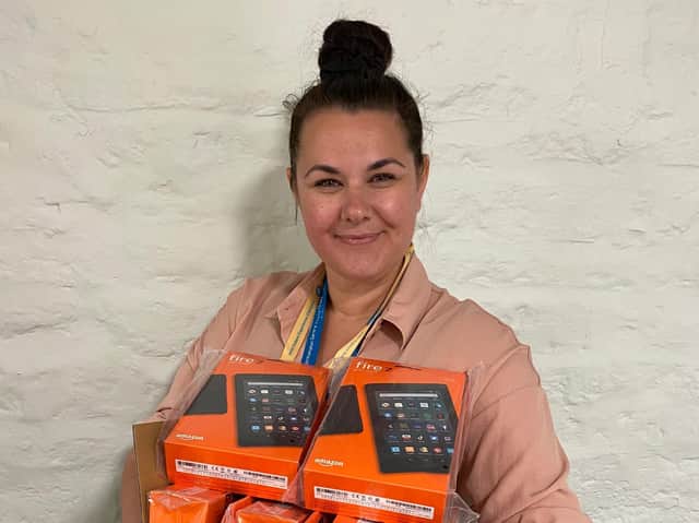 Patient experience lead Rachel Lovesy holding the tablets which were donated as part of the Amazon wish list appeal.