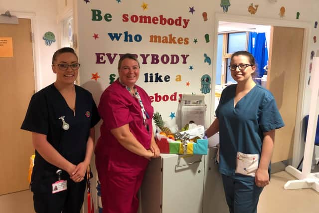Nurses in Paediatric A&E sharing a Windermere fruit hamper.