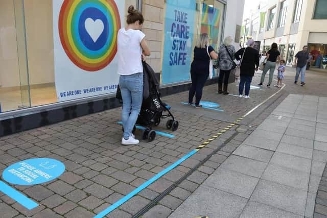 Shoppers queue in Corby.