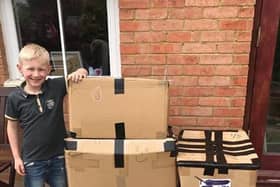 Dominic, 6, with his five boxes of inflatables