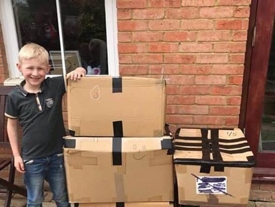 Dominic, 6, with his five boxes of inflatables