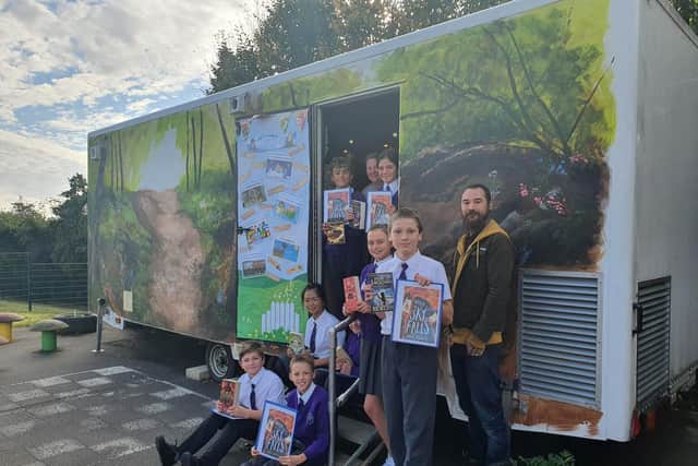 Michael Piper with students at their new forest-themed library.
