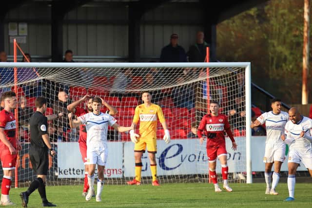 Referee Dean Watson points to the spot to award Buxton their last-gasp penalty as Kettering Town conceded late on in the 2-2 draw at Latimer Park. Pictures by Peter Short