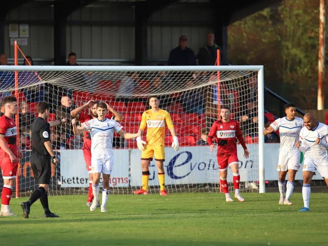 Referee Dean Watson points to the spot to award Buxton their last-gasp penalty as Kettering Town conceded late on in the 2-2 draw at Latimer Park. Pictures by Peter Short