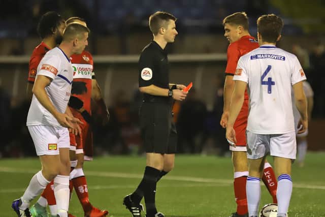 Poppies midfielder Harrison Neal was sent-off for a second bookable offence during extra-time