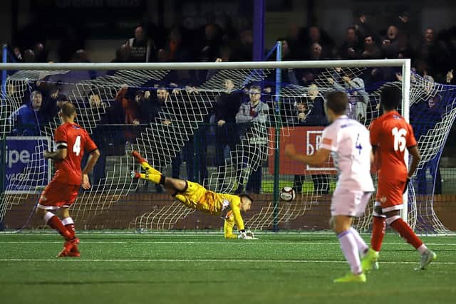 Kettering Town goalkeeper Jackson Smith is beaten by Diego De Girolamo's second goal which wrapped up Buxton's 3-1 win in the FA Cup replay at The Silverlands. Pictures by Peter Short