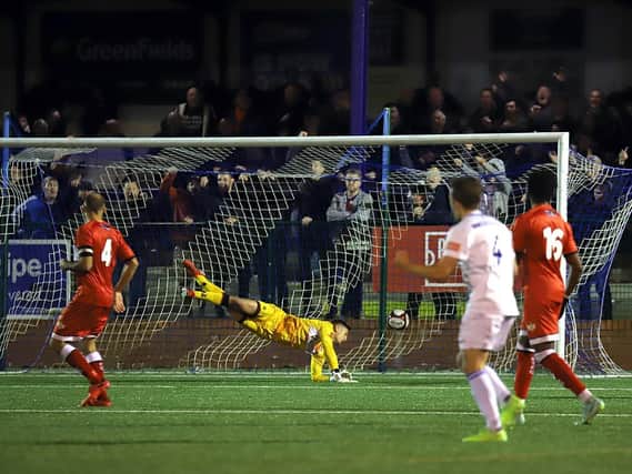 Kettering Town goalkeeper Jackson Smith is beaten by Diego De Girolamo's second goal which wrapped up Buxton's 3-1 win in the FA Cup replay at The Silverlands. Pictures by Peter Short