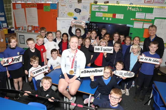 Gold medal-winning performance - Laura Sugar with pupils at Cranford Primary School